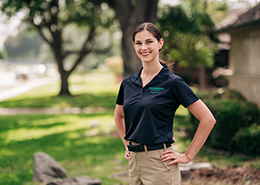 HouseMaster female inspector smiling with hands on hips.