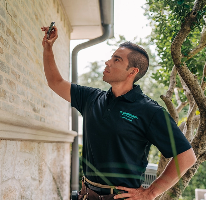 HouseMaster inspector checking eifs cladding.