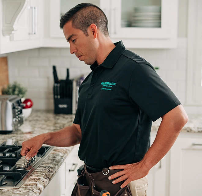 HouseMaster inspector checking stove top.