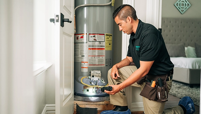 HouseMaster inspector checking hot water heater.