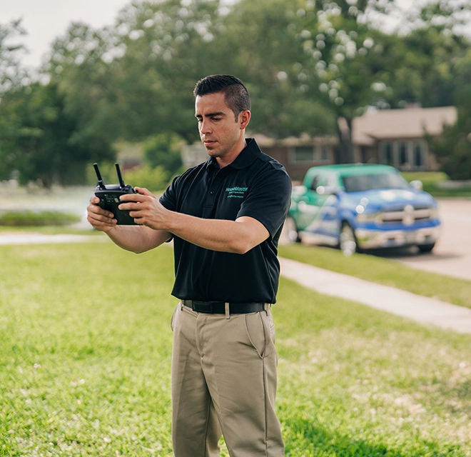 HouseMaster inspector holding drone controller.