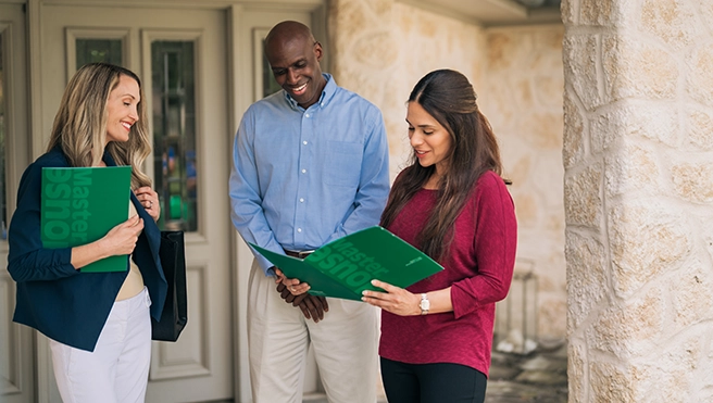 HouseMaster inspector showing couple inspection details using green pamphlets.