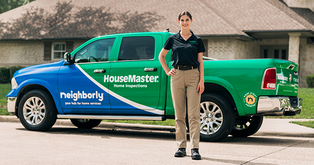 Woman standing in front of a branded HouseMaster truck.