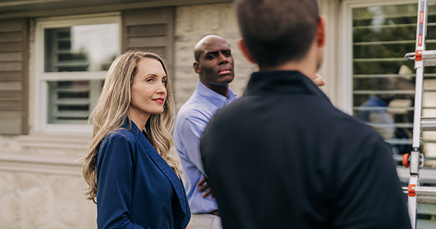 Three people gathered outside for a consult.