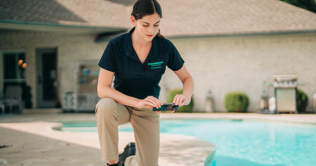 Technician taking photo of pool.