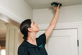 HouseMaster inspector checking overhead light fixture.