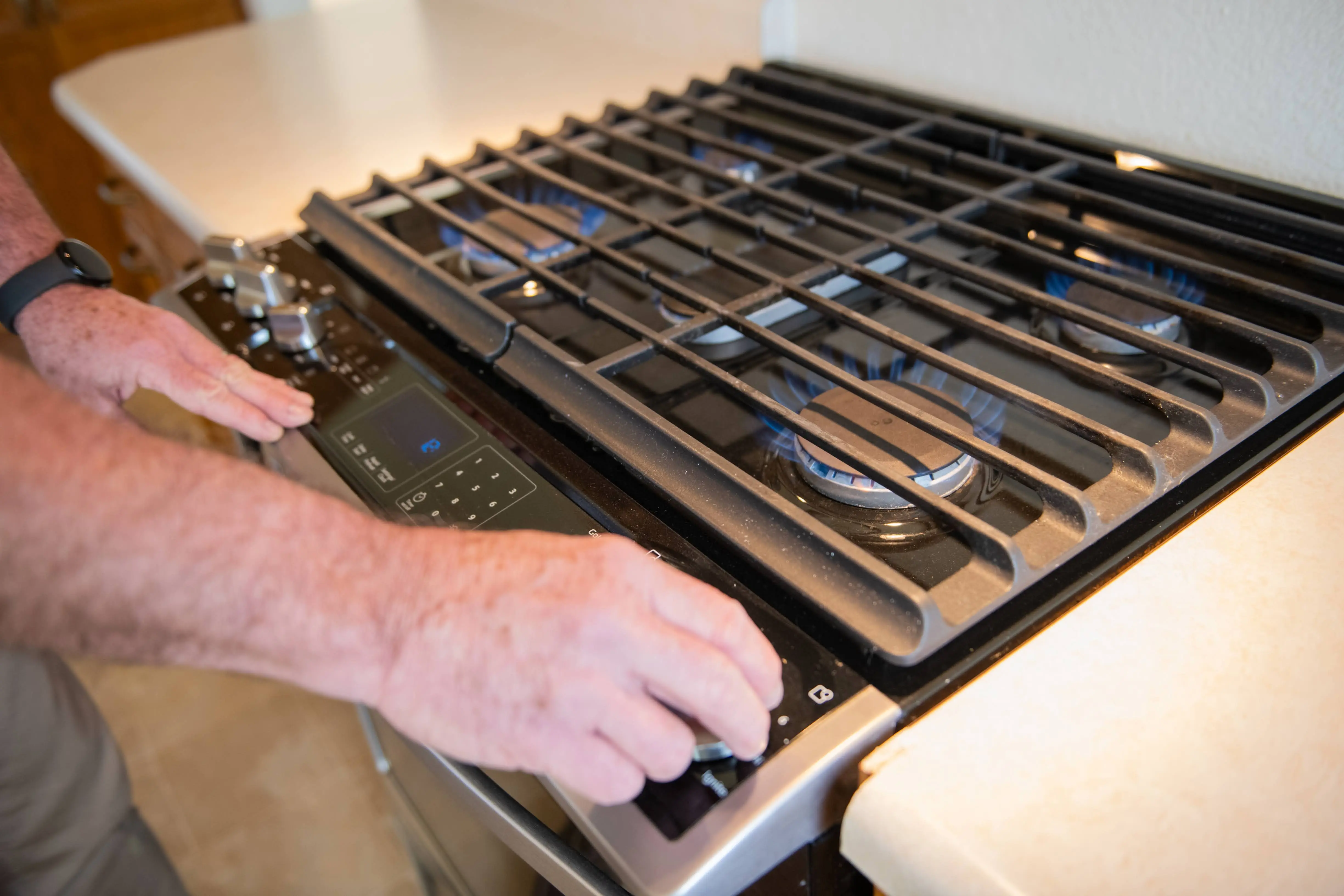 HouseMaster technician inspecting a kitchen appliance.