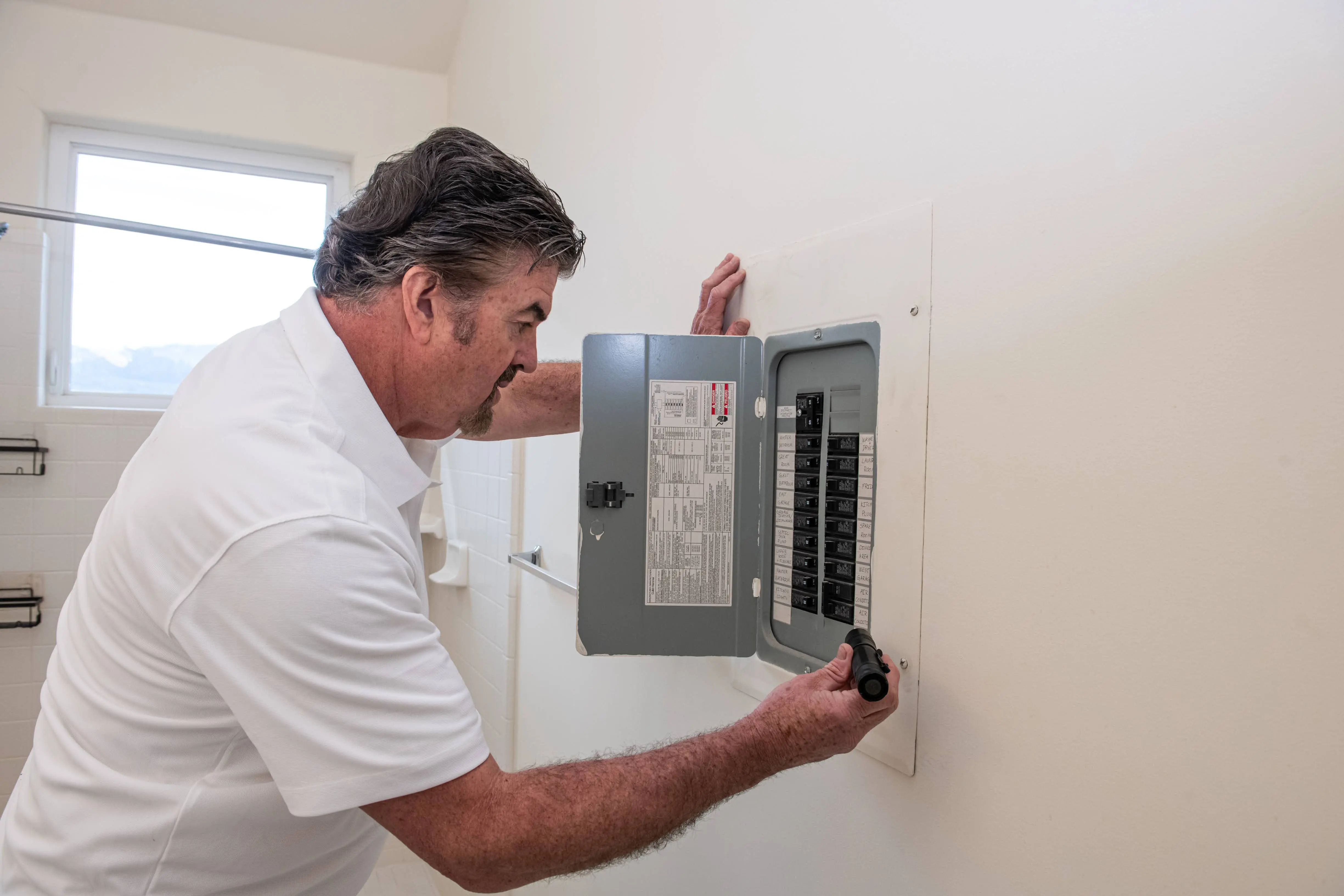HouseMaster technician inspecting electrical.