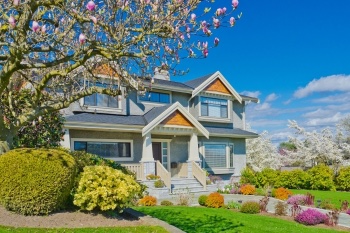 A beautiful house with a tree in front of it.