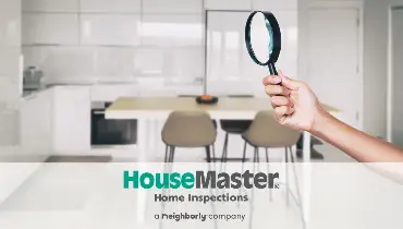 Bright kitchen with magnifying glass and HouseMaster logo.